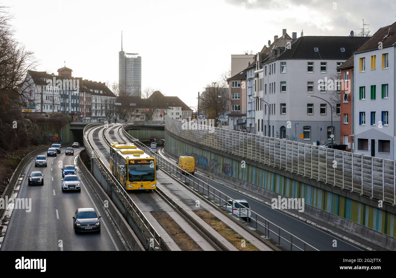 Essen, North Rhine-Westphalia, Germany - Cars and a public service bus drive on the A40 motorway through downtown Essen, in the back the Westenergie Tower, formerly RWE Tower. Stock Photo