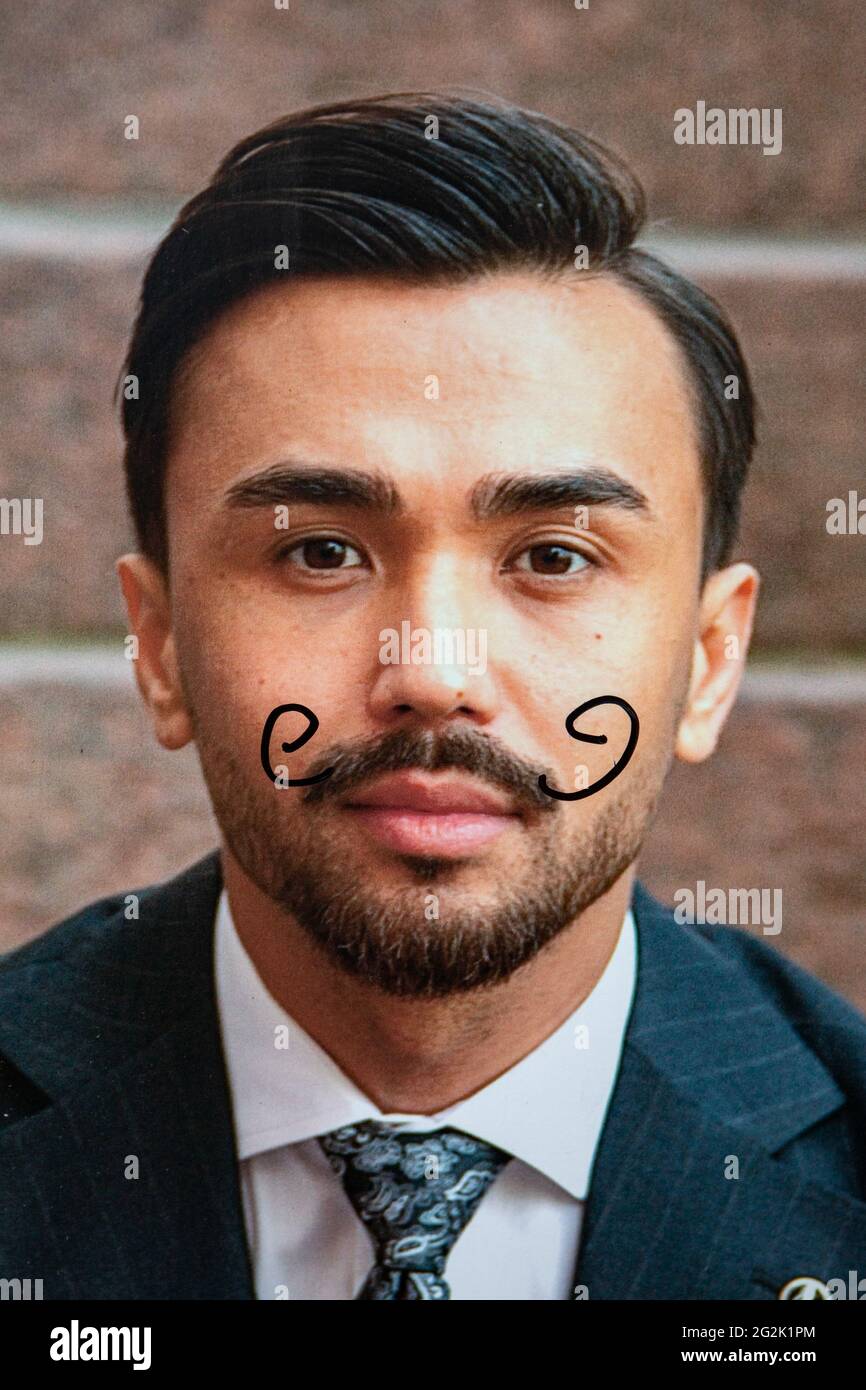 Election campaign poster defaced with hand-drawn moustache Stock Photo