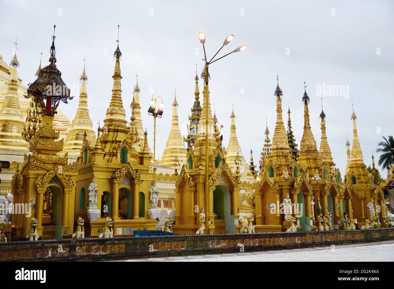 Small shrines line up around the complex of Shwedagon Pagoda in Yangon, Myanmar Stock Photo