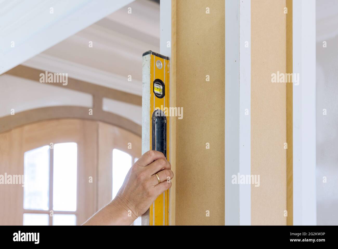 Worker using leveling instrument check appropriate wood columns using level Stock Photo