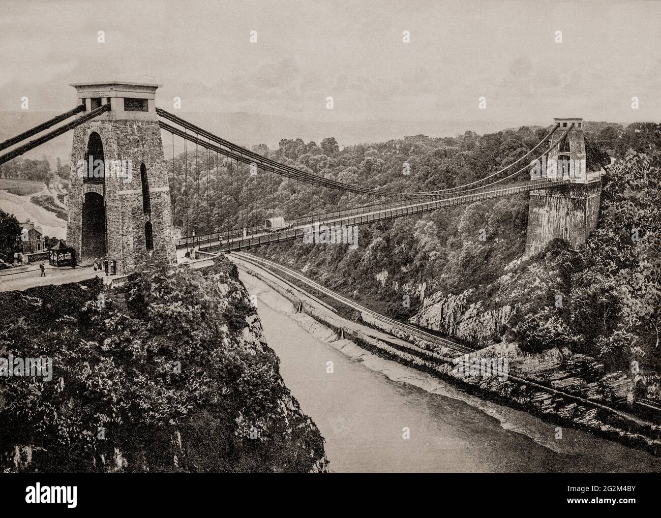 A late 19th century view of a horse and cart crossing the Clifton Suspension Bridge spanning the Avon Gorge and the River Avon, linking Clifton in Bristol to Leigh Woods in North Somerset. Since opening in 1864, it has been a toll bridge, the income from which provides funds for its maintenance. The bridge was built to a design by William Henry Barlow and John Hawkshaw, based on an earlier design by Isambard Kingdom Brunel. Stock Photo