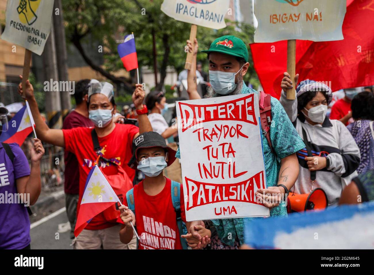 Metro Manila, Philippines. 12th June 2021. Activists shout slogans during a protest in front of the Chinese consulate marking Independence Day in the financial district of Makati. Various groups called on China to stop its maritime activities in the disputed South China Sea, which endangers peace and stability in the region. Credit: Majority World CIC/Alamy Live News Stock Photo