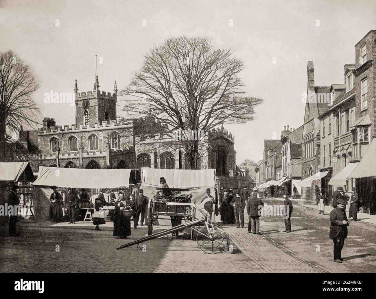 A late 19th century view of the market place in front of All Saints' Church in Huntingdon, a market town in Cambridgeshire, England, chartered by King John in 1205. It was the birthplace of Oliver Cromwell in 1599, who became its Member of Parliament (MP) in the 17th century. Stock Photo