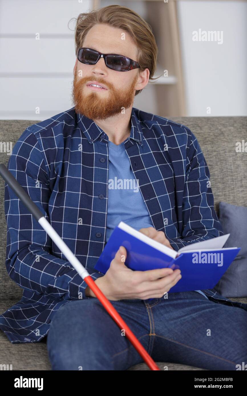 visually impaired young man reading book by braille Stock Photo Alamy