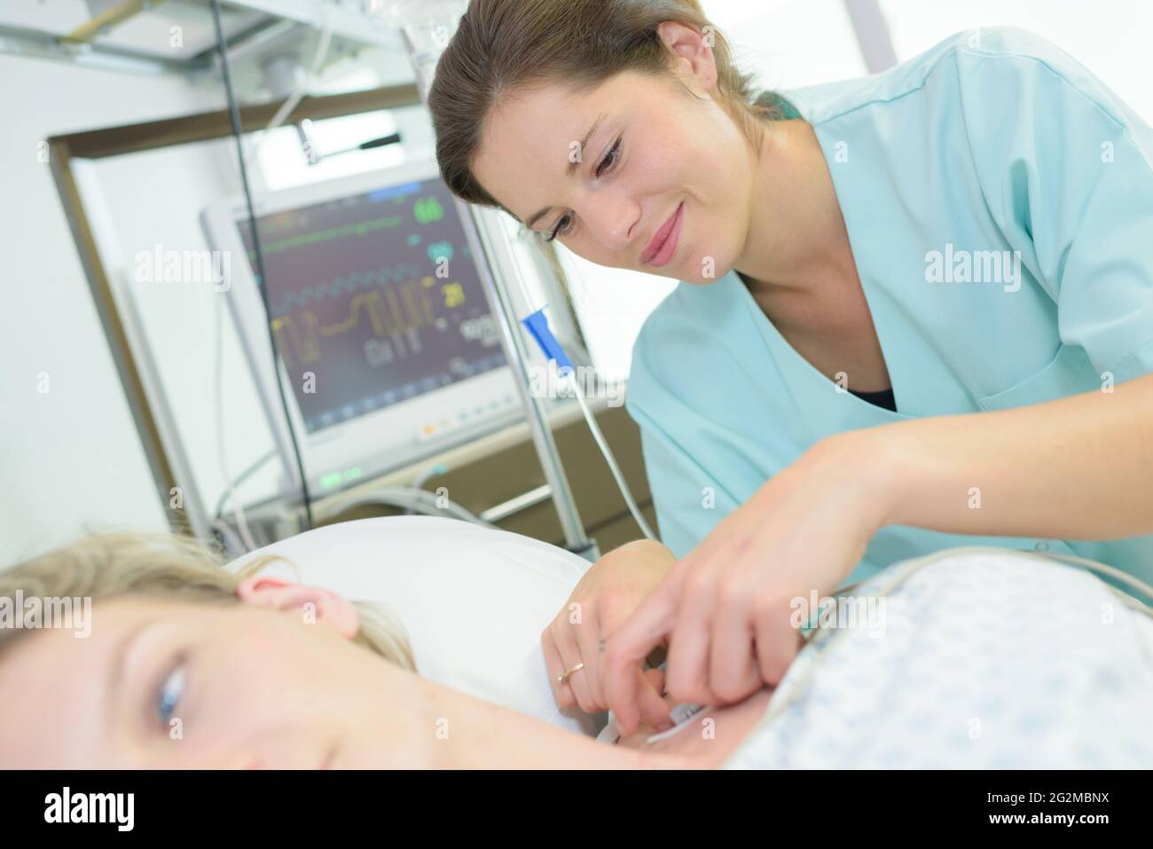 nurse tending to patients neck perfusion Stock Photo