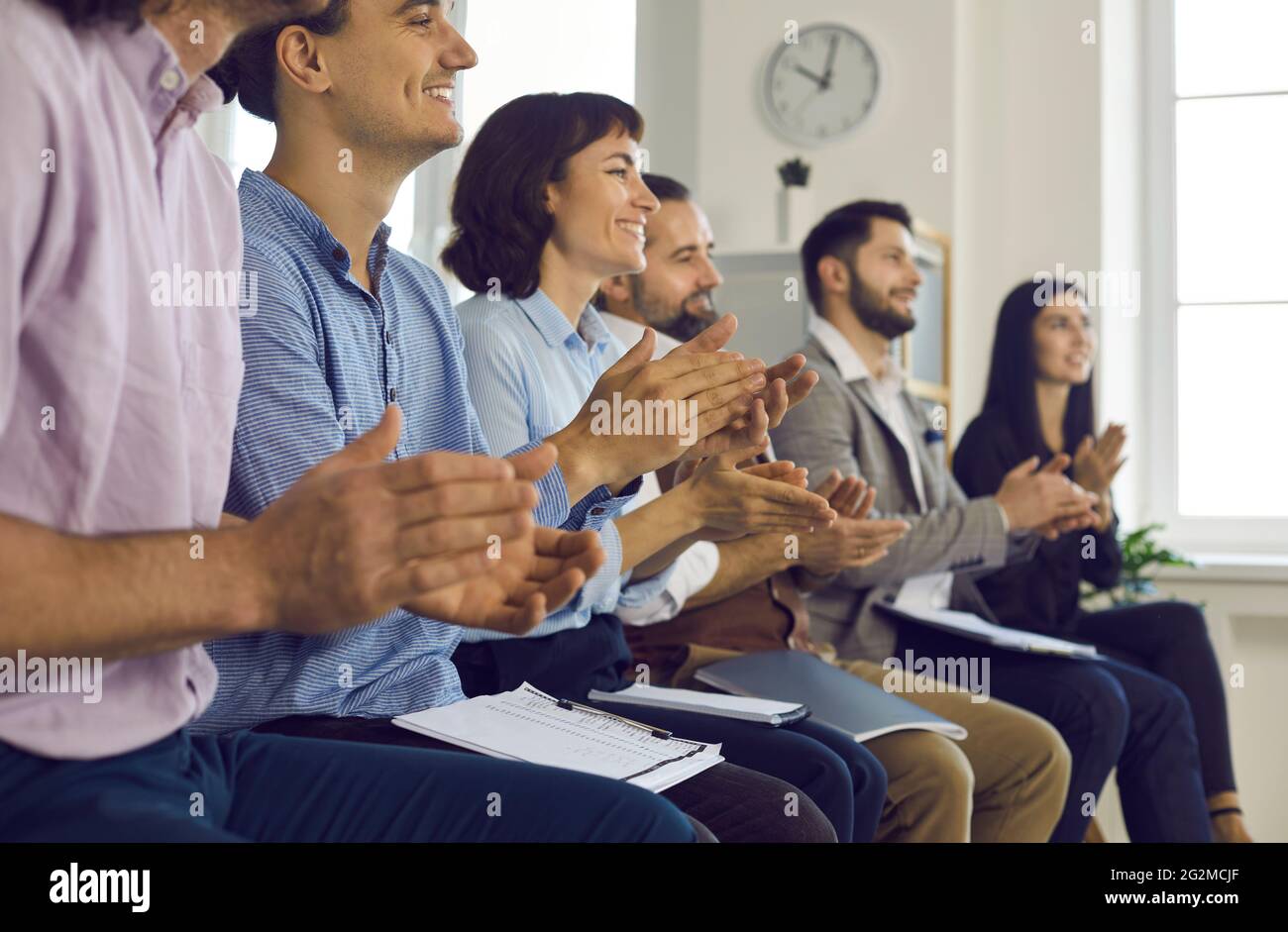 A group of young satisfied people colleagues feel happy in training Stock Photo