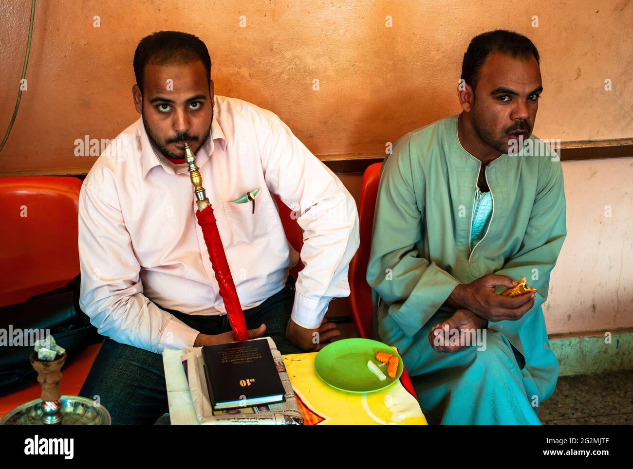 Aswan, Egypt - January 4 2011: Egyptian Man Smoking a Shisha Water Pipe or Hookah in a Cafe Stock Photo