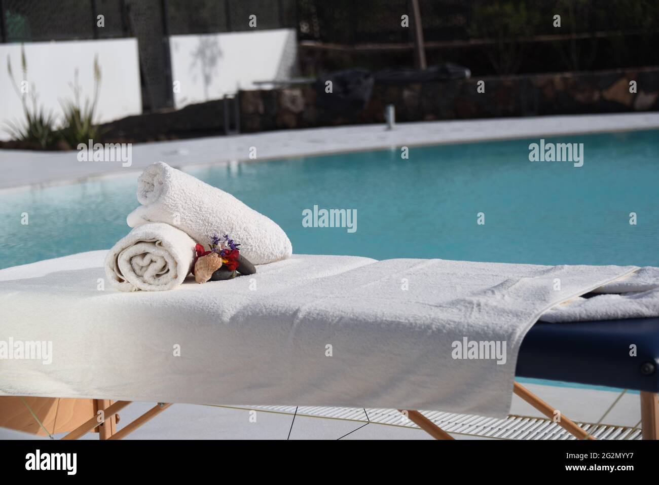 Portable massage table on the poolside Stock Photo