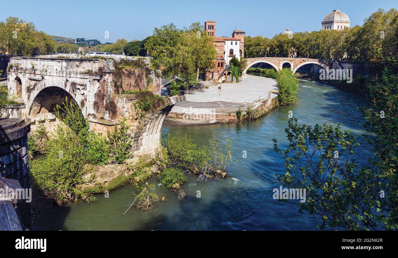 Rome, Italy.  Isola Tiberina or Tiber Island seen from Ponte Paletino The ruined single span is of the so-called Ponte Rotto, or Broken Bridge, which Stock Photo