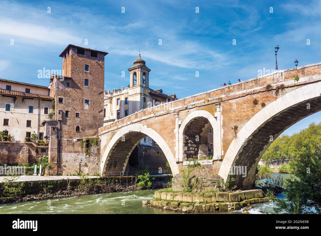 Rome, Italy.  Isola Tiberina or Tiber Island with the Ponte Fabricio built in the first century BC.  The historic centre of Rome is a UNESCO World Her Stock Photo