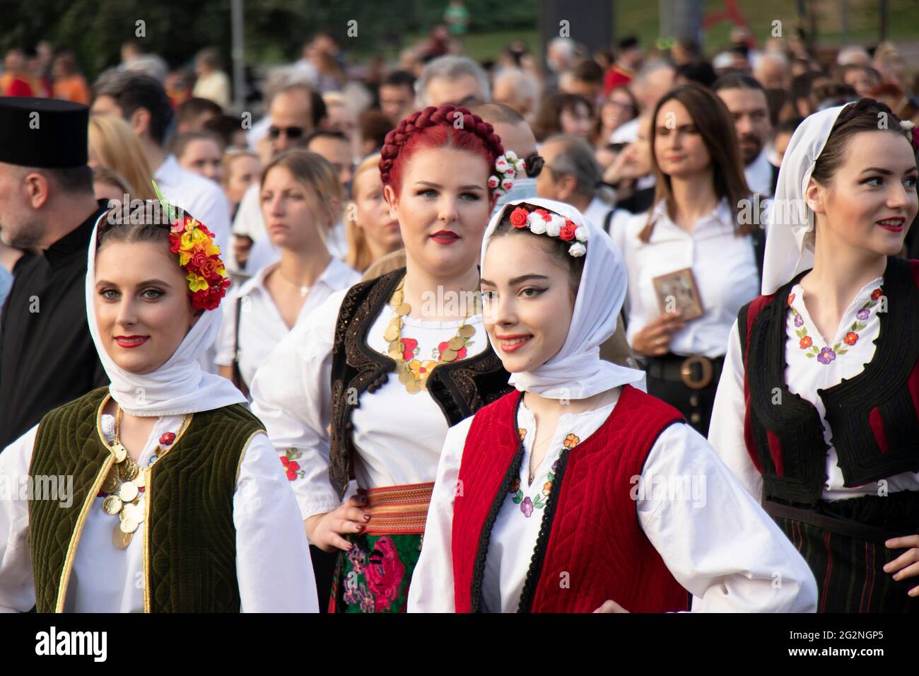 Belgrade, Serbia - June 10, 2021: Young women folk dancers wearing traditional costumes participate in religious procession  to celebrate Belgrade’s P Stock Photo