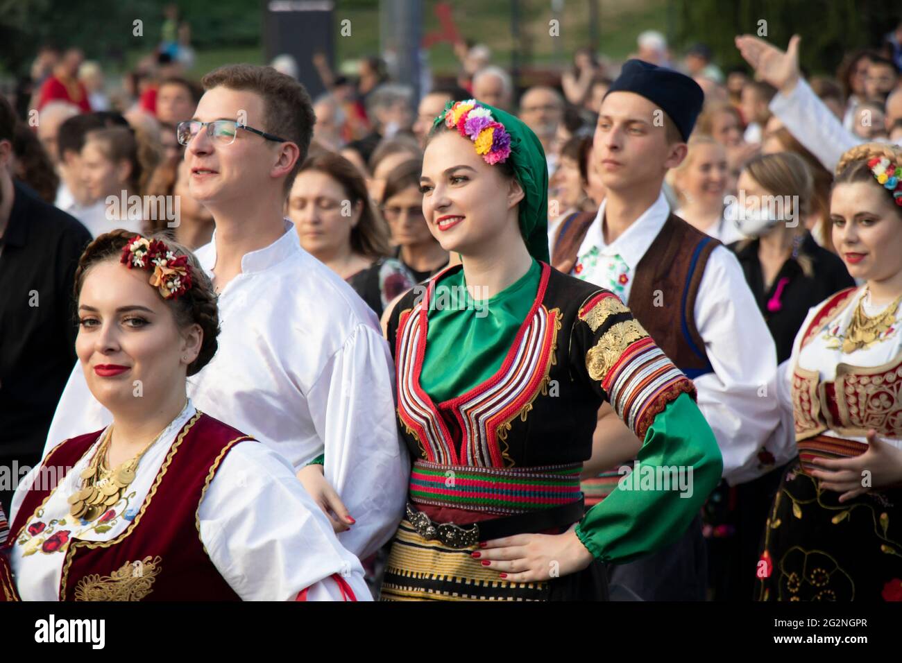 Belgrade, Serbia - June 10, 2021: Young people folk dancers wearing traditional costumes participate in religious procession  to celebrate Belgrade’s Stock Photo