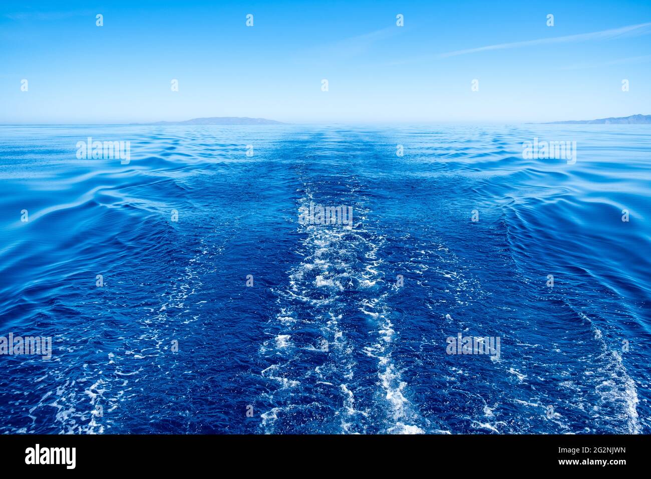 Boat wake, prop wash foam, blue calm sea and clear sky background, view  from the ship. Sailing in Aegean sea Stock Photo - Alamy