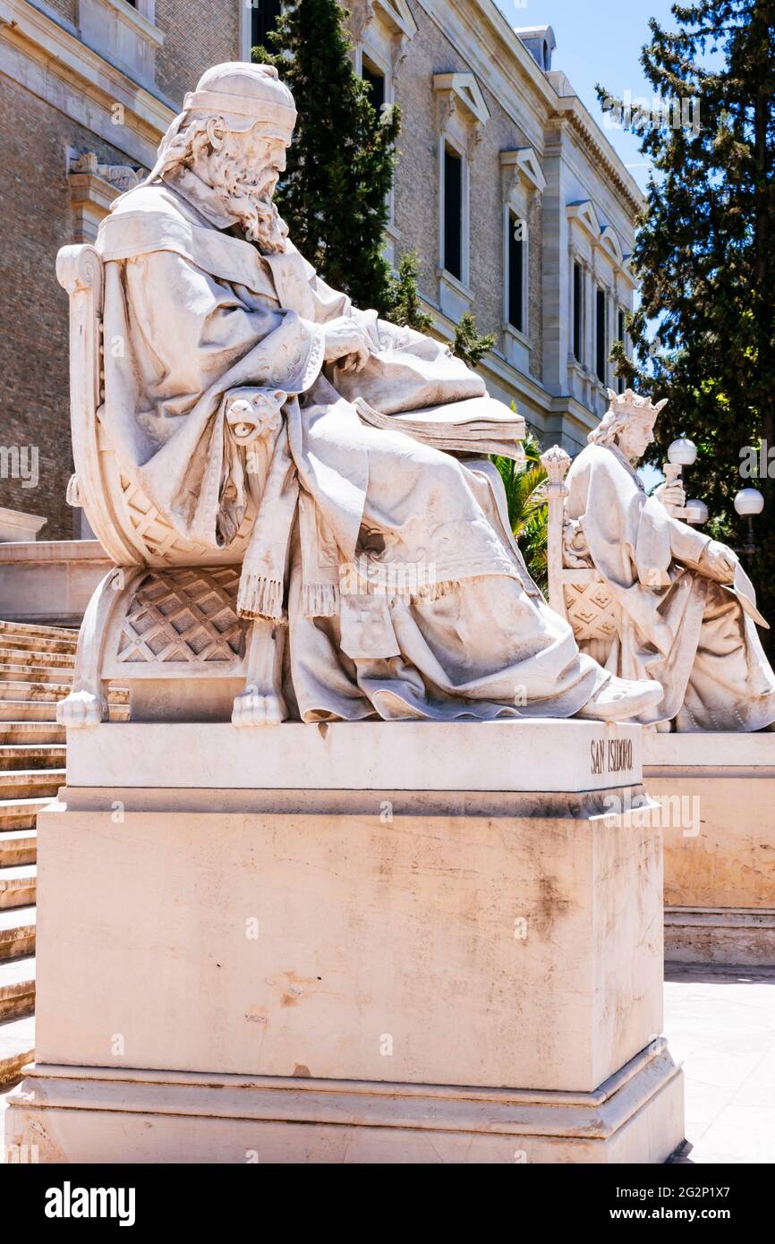 Statues of Isidore of Seville (L) and Alfonso X the Wise (R) on the steps of the main facade of the library. Building of National Library - Biblioteca Stock Photo