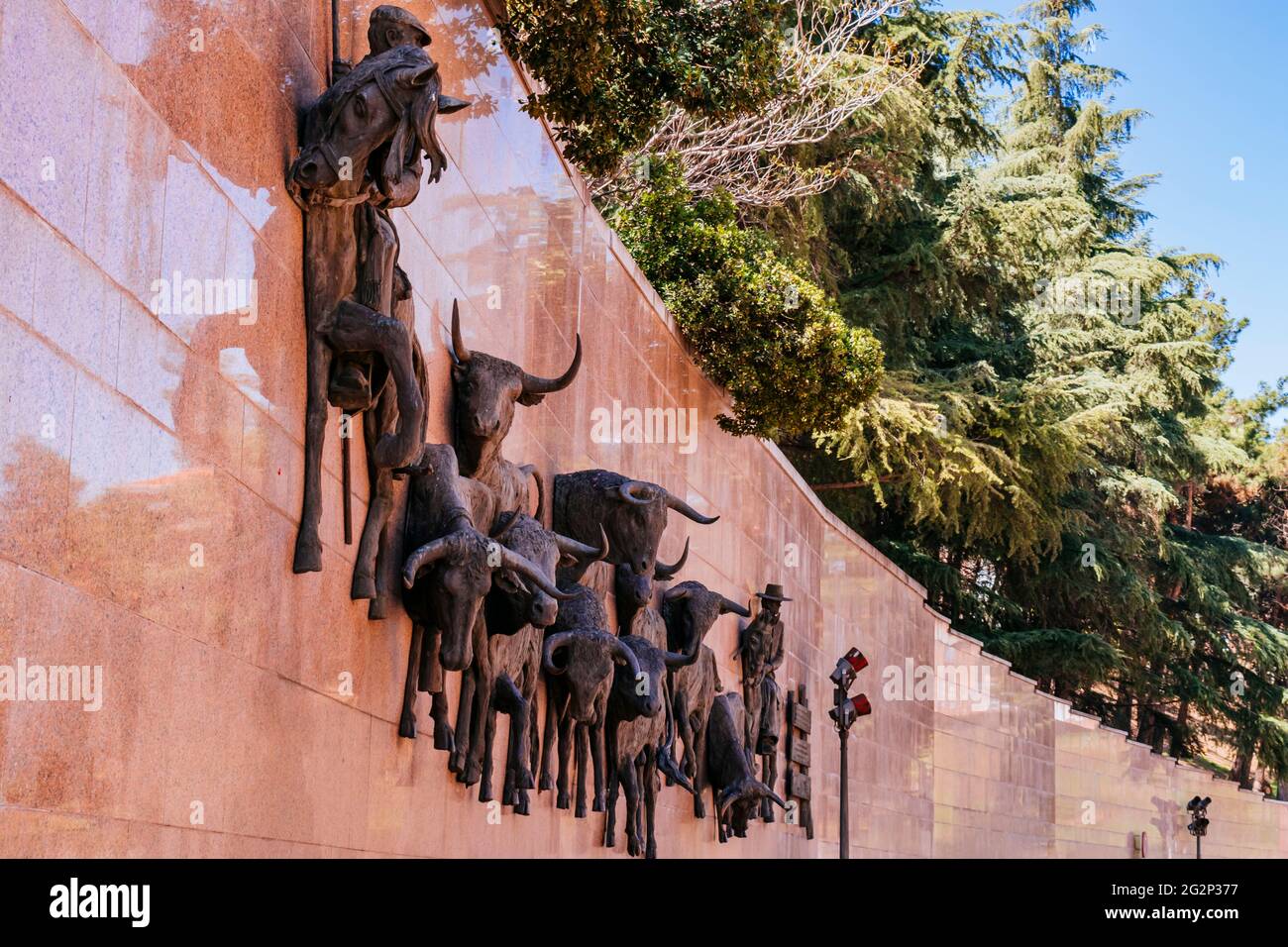 Huge bronze bas-relief, called 'El Encierro' by the Barcelona sculptor Luis Sanguino. The plaza de toros de Las Ventas, known simply as Las Ventas, is Stock Photo