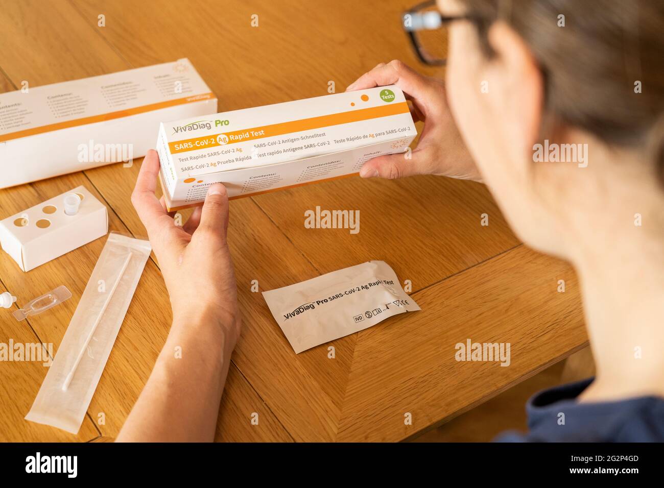 A woman taking a self diagnostic VivaDiag SARS-CoV-2 Ag Rapid Test for Covid-19 at home Stock Photo