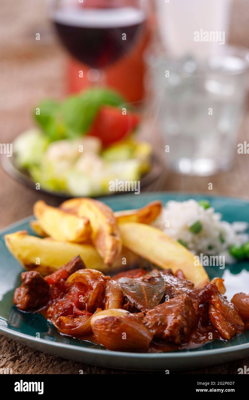 greek stifado meat stew with fries Stock Photo Alamy