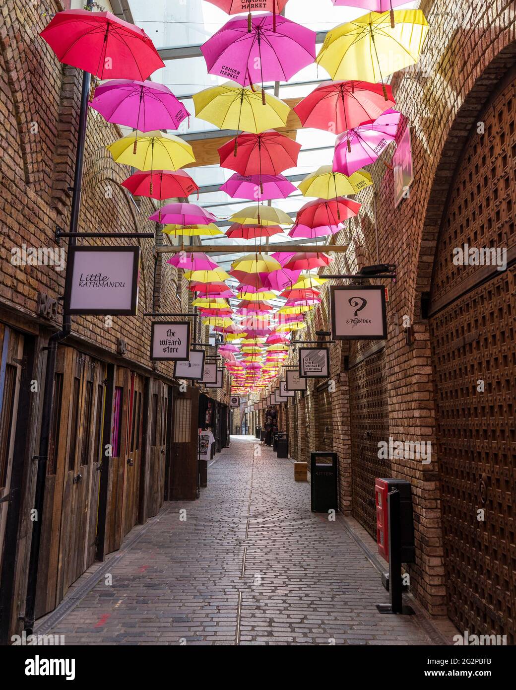 Camden Market inside shops on a sunny day with colourful umbrellas hanging  above. London - 12th June 2021 Stock Photo - Alamy