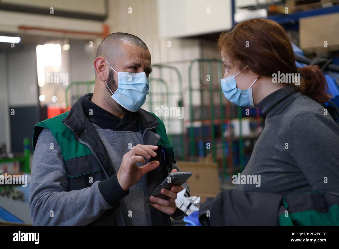 Industrial workers with face masks protected against corona virus ...