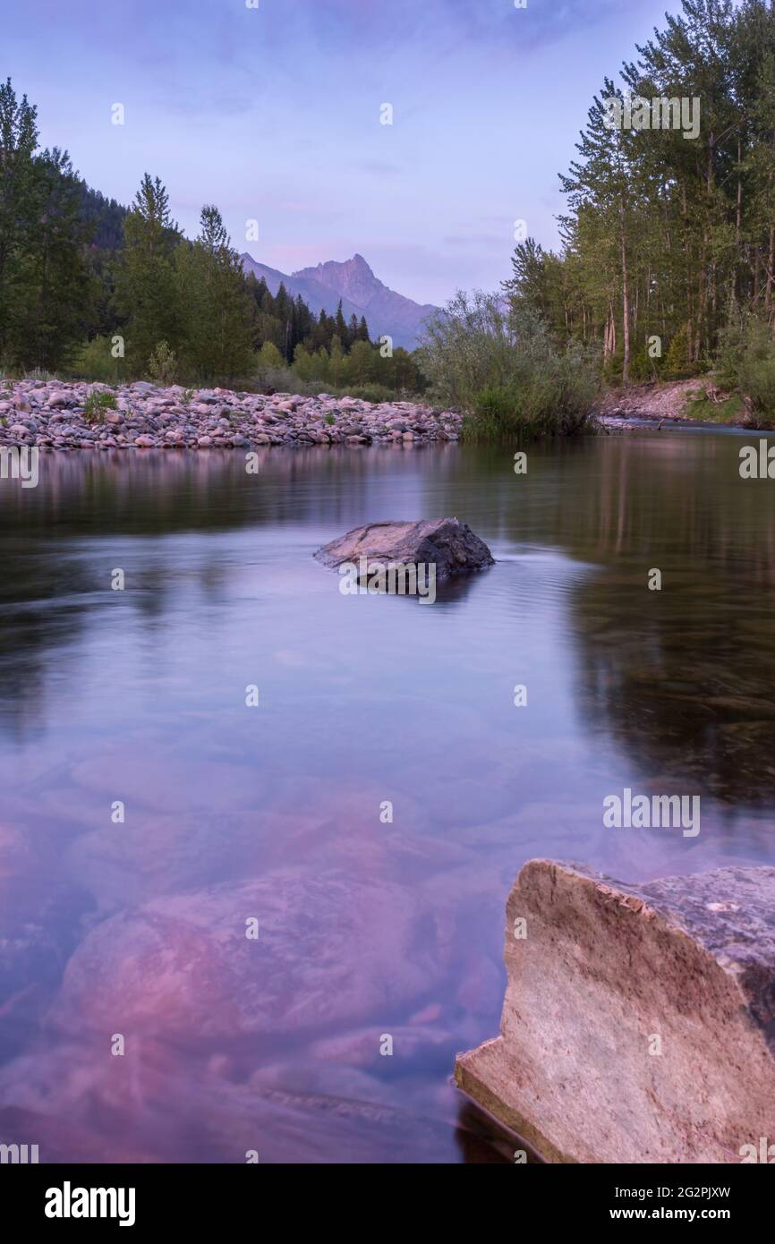 Middle Fork Flathead River in Glacier National Park. Sunset reflected in water with Mount St Nicholas in background Stock Photo