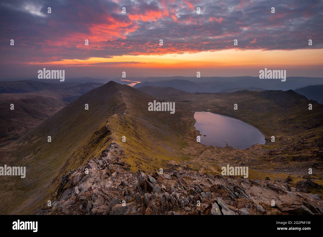 Breathtaking sunrise at the summit of Helvellyn; one of the Lake Districts most popular mountain hikes. Stock Photo