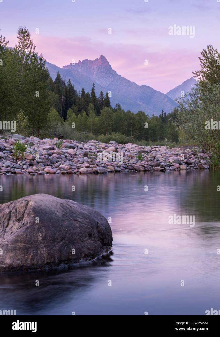 Middle Fork Flathead River in Glacier National Park. Sunset reflected in water with Mount St Nicholas in background Stock Photo