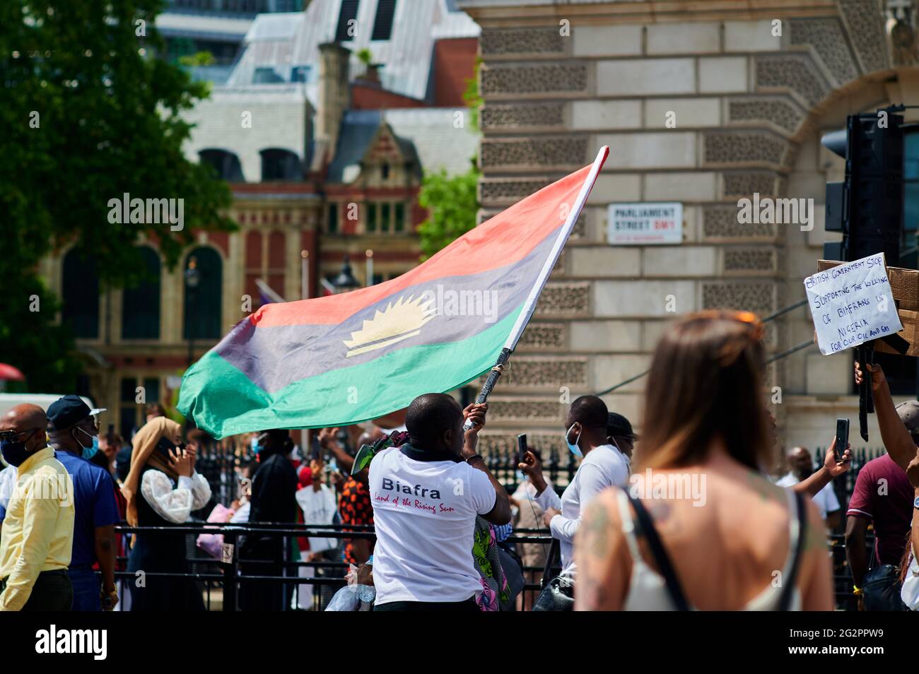 London  UK - 12 June 2021 - Protester waving Biafran large flag at Biafra protest on corner of whitehall and westminster square in Central london whi Stock Photo