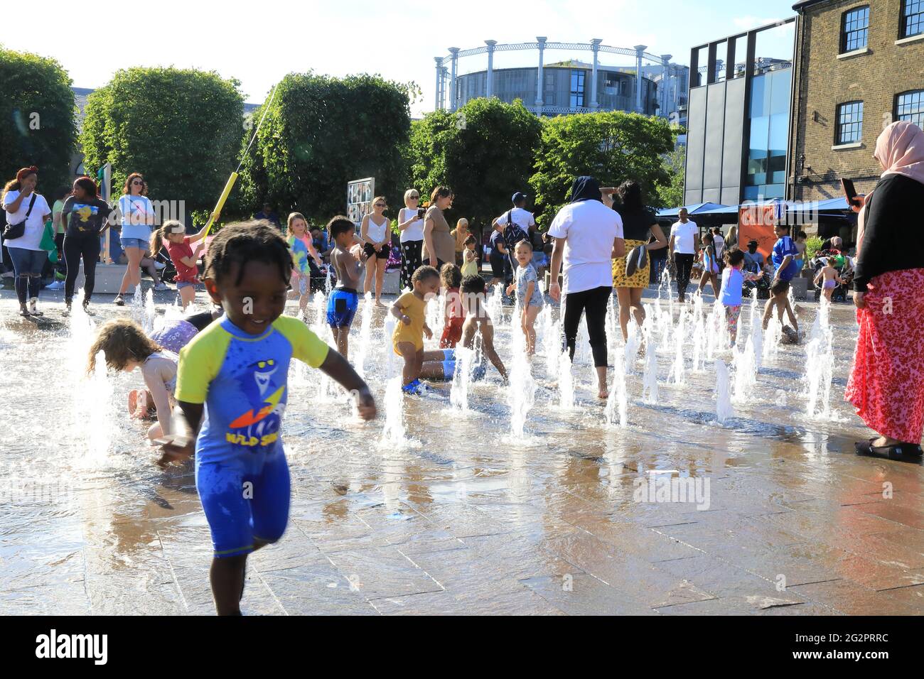 London, UK, June 12th 2021. Children has great fun in the fountains in Granary Square, at Kings Cross, north London, as temperatures soared, the start of a heatwave as warm air arrived from Bermuda. Monica Wells/Alamy Live News Stock Photo