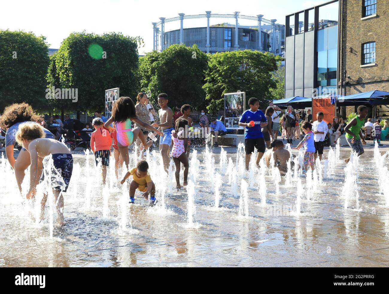 London, UK, June 12th 2021. Children has great fun in the fountains in Granary Square, at Kings Cross, north London, as temperatures soared, the start of a heatwave as warm air arrived from Bermuda. Monica Wells/Alamy Live News Stock Photo