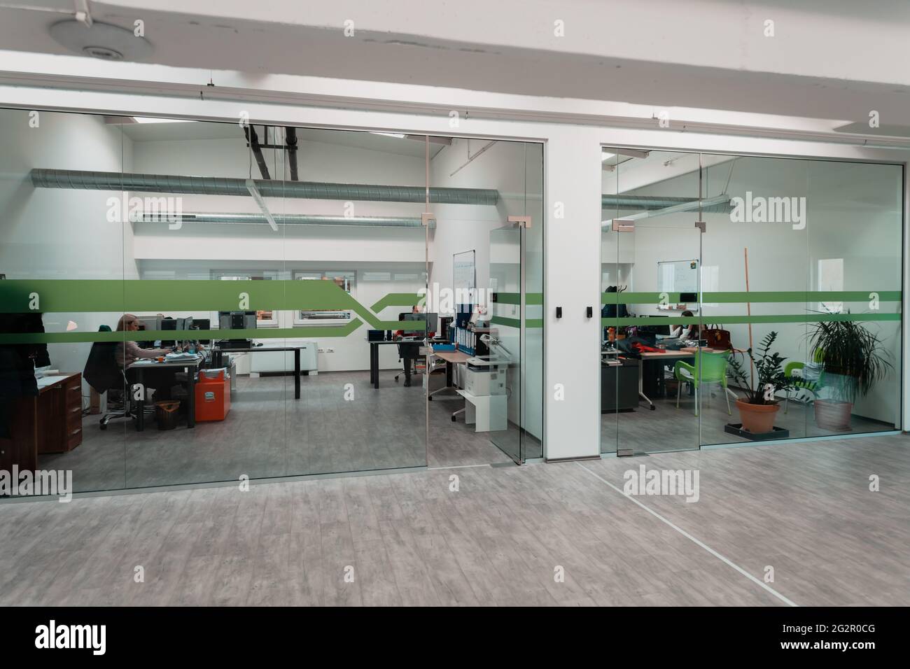 A modern glass office in the industry. Office with computers, tablets and modern devices. Stock Photo