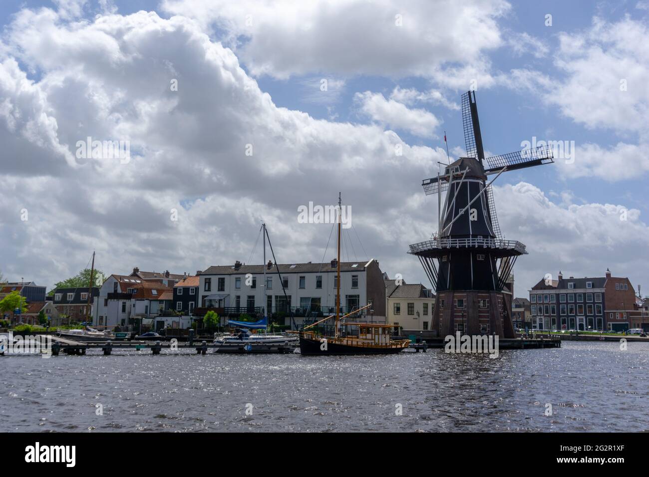 Haarlem, Netherlands - 21 May, 2021: view of the Dee Adrian Windmill and Binnen Spaarne River in Haarlem Stock Photo