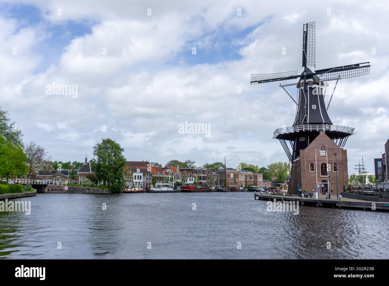 Haarlem, Netherlands - 21 May, 2021: view of the Dee Adrian Windmill and Binnen Spaarne River in Haarlem Stock Photo