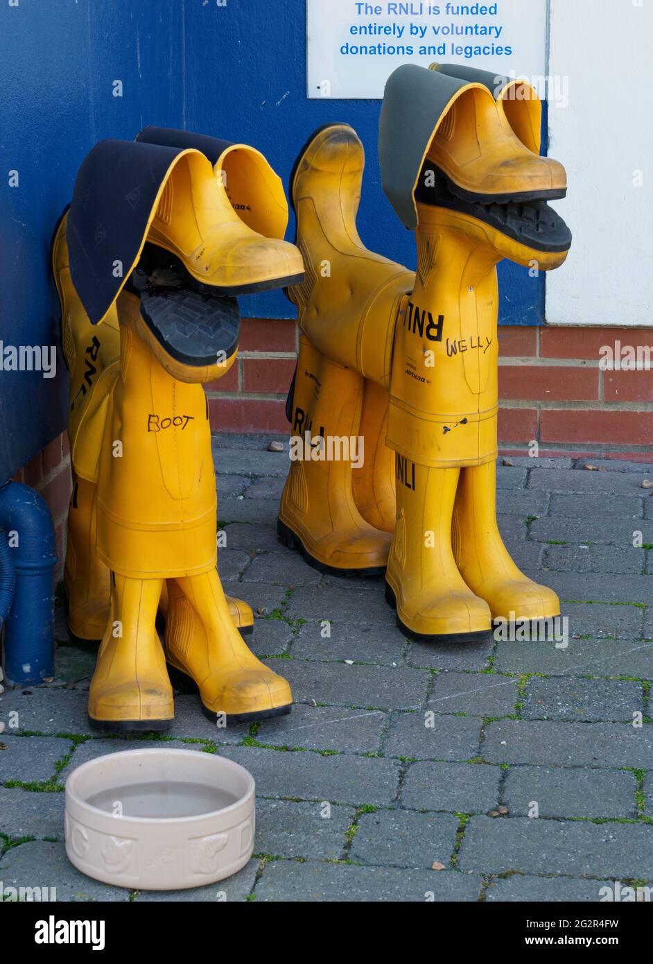 RNLI wellington boots formed into the shape of 2 dogs, at the RNLI boathouse, Hastings, East Sussex, U.K. Stock Photo