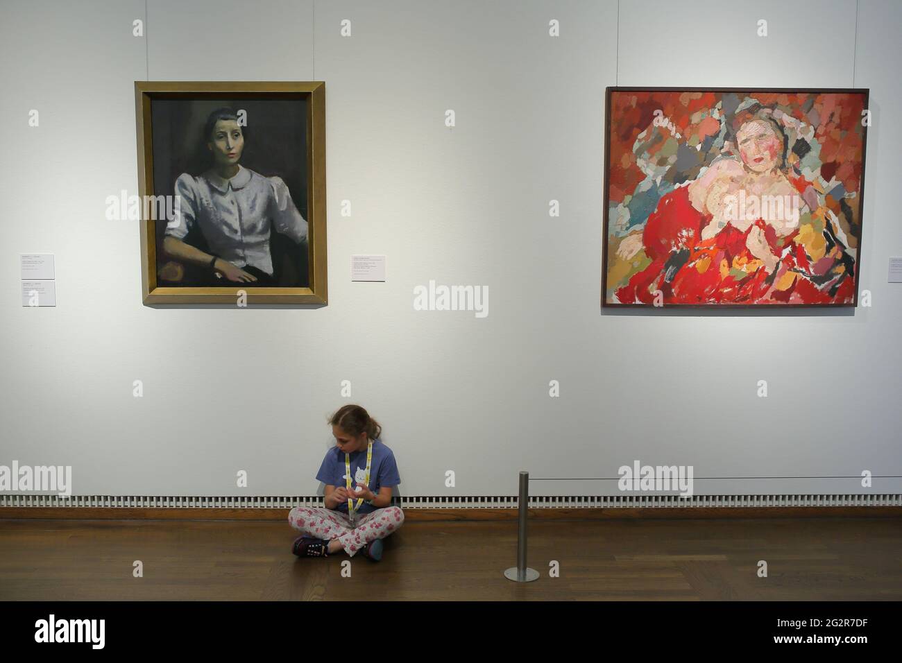 tired young girl taking rest in exhibition hall of Leopold museum Stock Photo