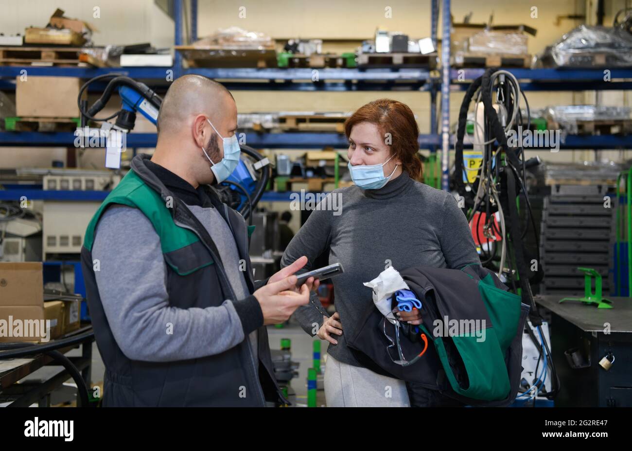 Industrial workers with face masks protected against corona virus ...
