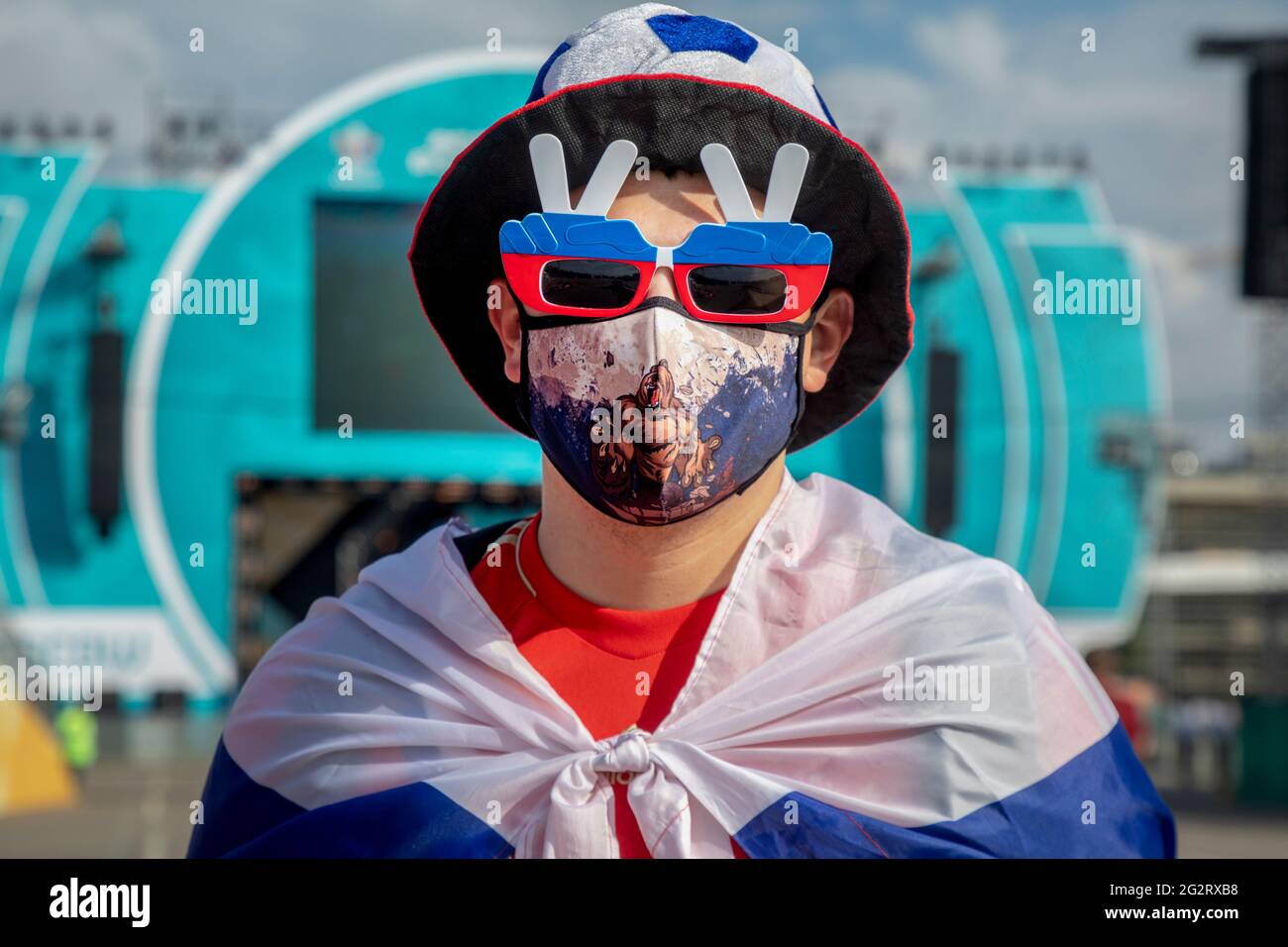 Moscow, Russia. 12th of June, 2021 A football fan wearing face mask visits  the Fan Zone where will be streaming the UEFA Euro 2020 Group B match  between Belgium and Russia, near