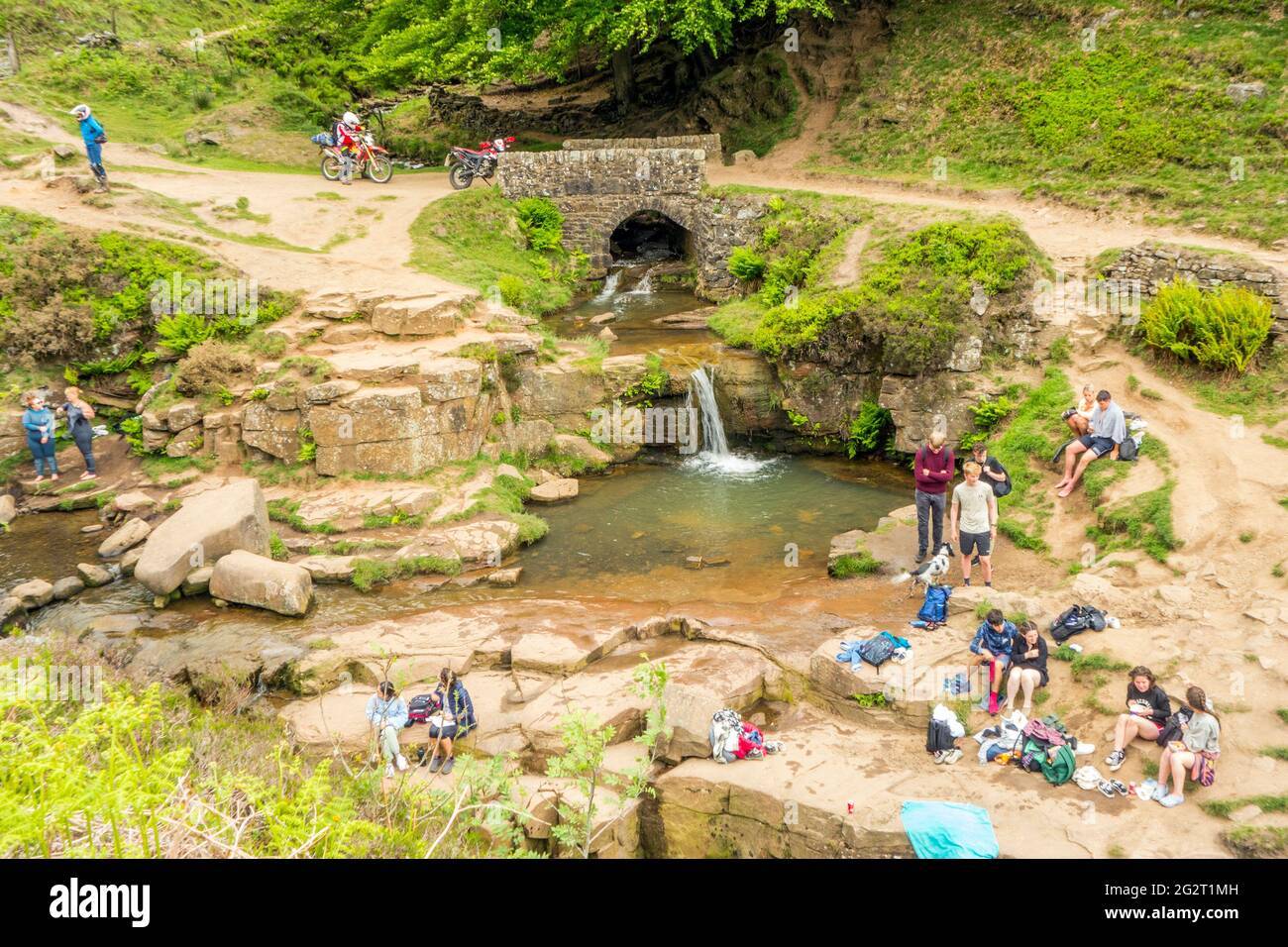 People picnicking and swimming in  the river Dane at the Three Shire Heads  where Cheshire, Derbyshire and Staffordshire meet in the Peak District Stock Photo