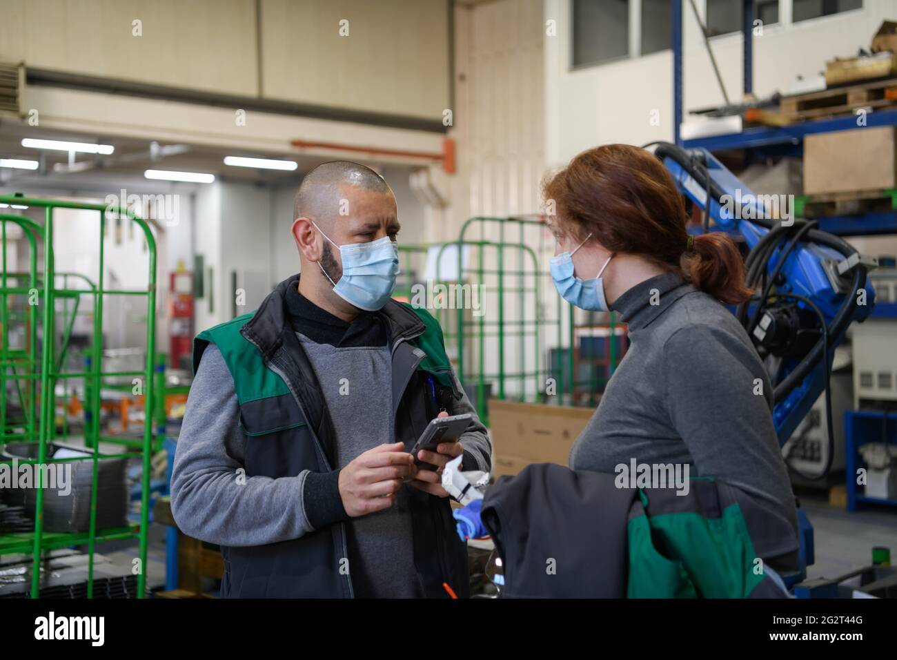 Industrial workers with face masks protected against corona virus ...
