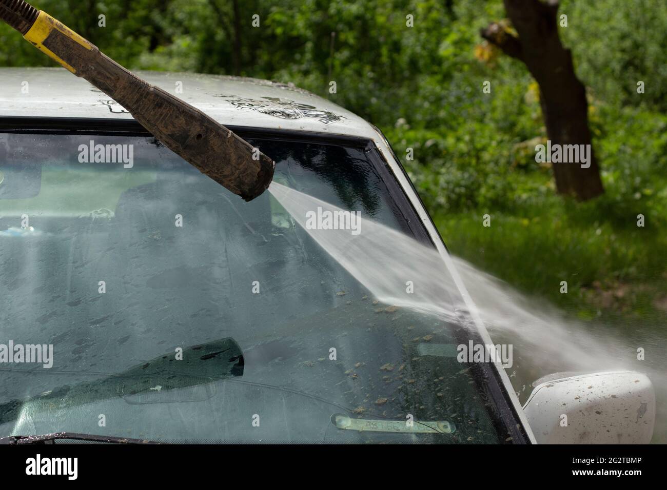 Washing the windshield from dirt. The car is washed by the pressure of