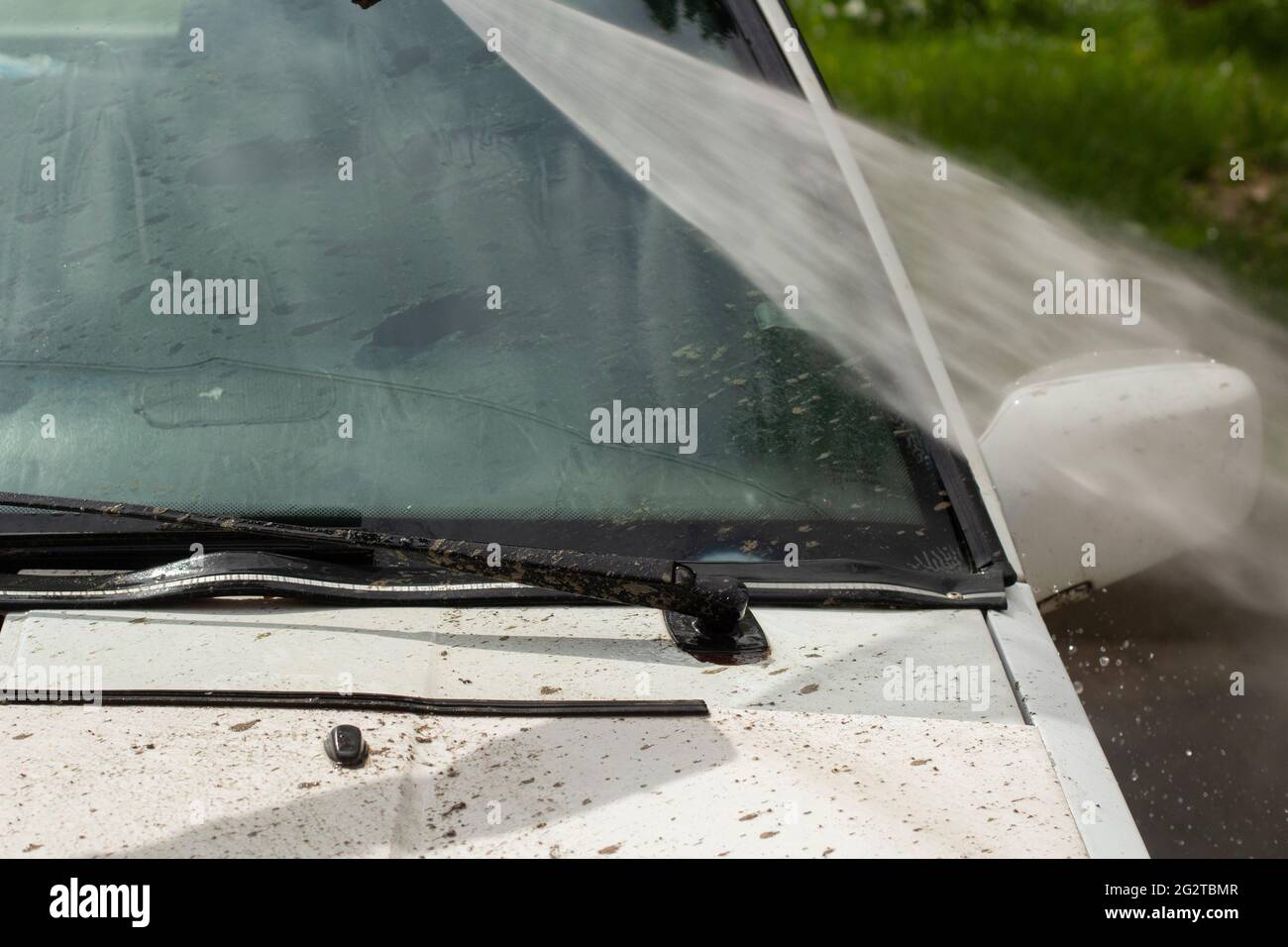 Washing the windshield from dirt. The car is washed by the pressure of
