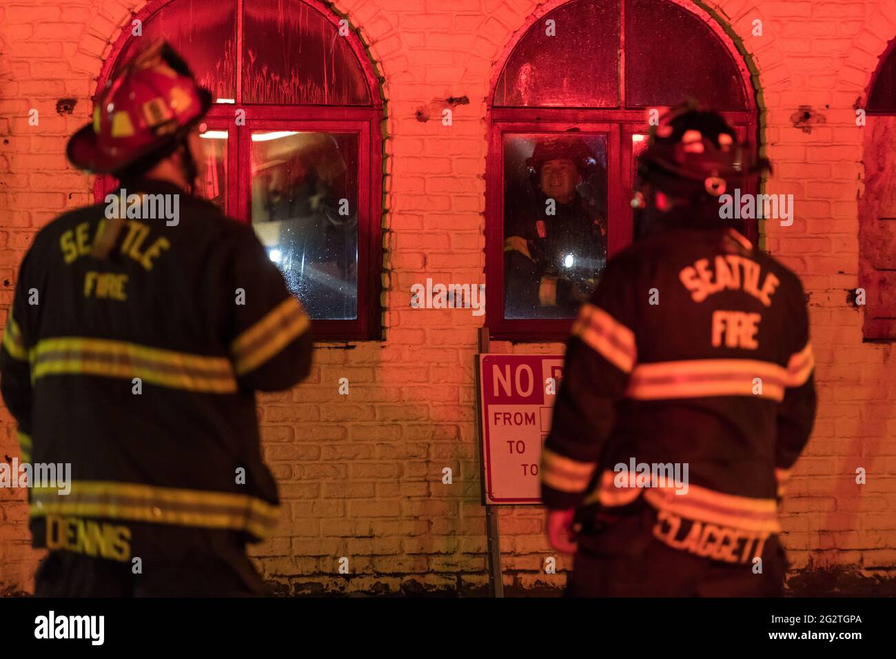 Seattle, USA. 18th Apr, 2021. Seattle Fire Department putting out hotspots after responding to a structure fire at Pesos restaurant in Lower Queen Ann Stock Photo