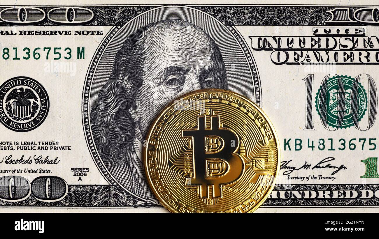 Bitcoin vs US dollar, gold bit coins on 100 dollar bill. Digital crypto currency bitcoin and Franklin portrait on money note. Concept of bank, bitcoin Stock Photo