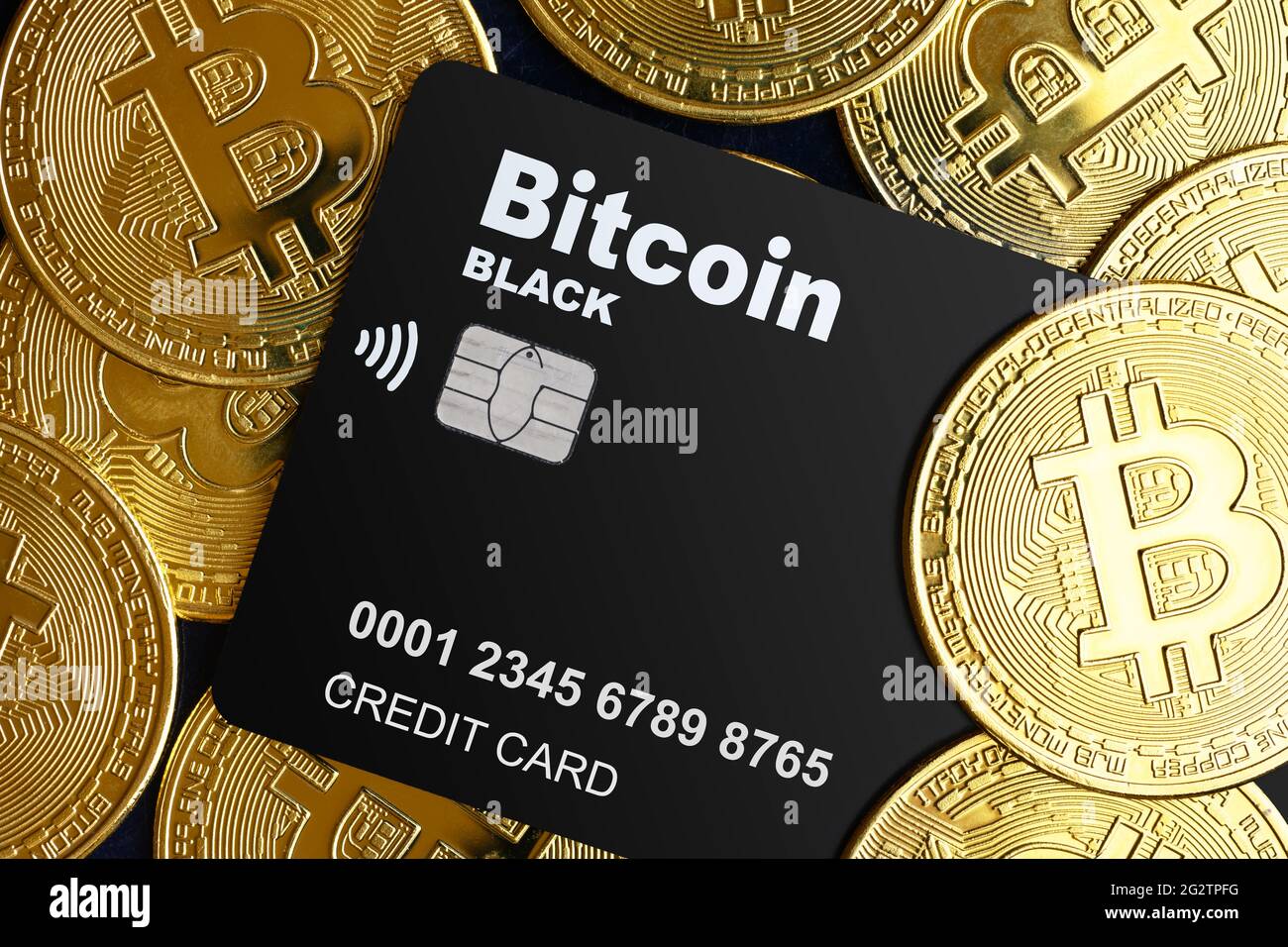Bitcoin credit card and pile of bit coins, digital crypto currency bitcoin for electronic transactions. Gold bitcoins and plastic bank card. Concept o Stock Photo