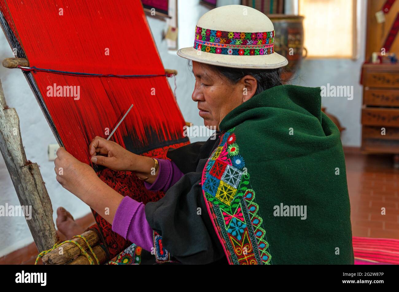 Bolivian senior indigenous woman portrait in traditional clothing showing traditional Jalq'a textile weaving, Sucre, Bolivia. Stock Photo