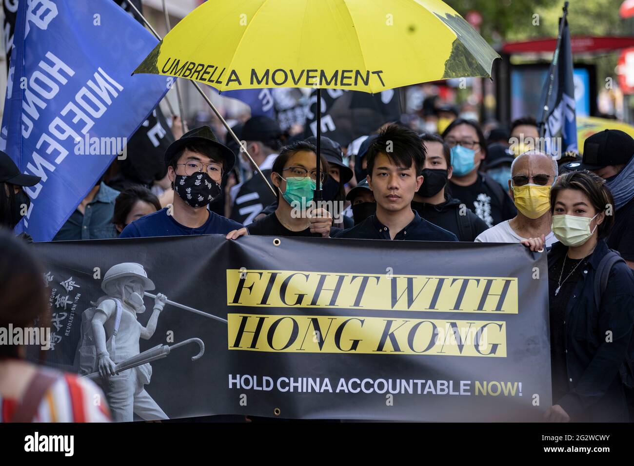 London Uk 12th June 21 Pro Democracy Activists Simon Cheng L Finn Lau C Hold Banner That Reads Fight With Hong Kong During A Rally In London Uk On June 12 21 To