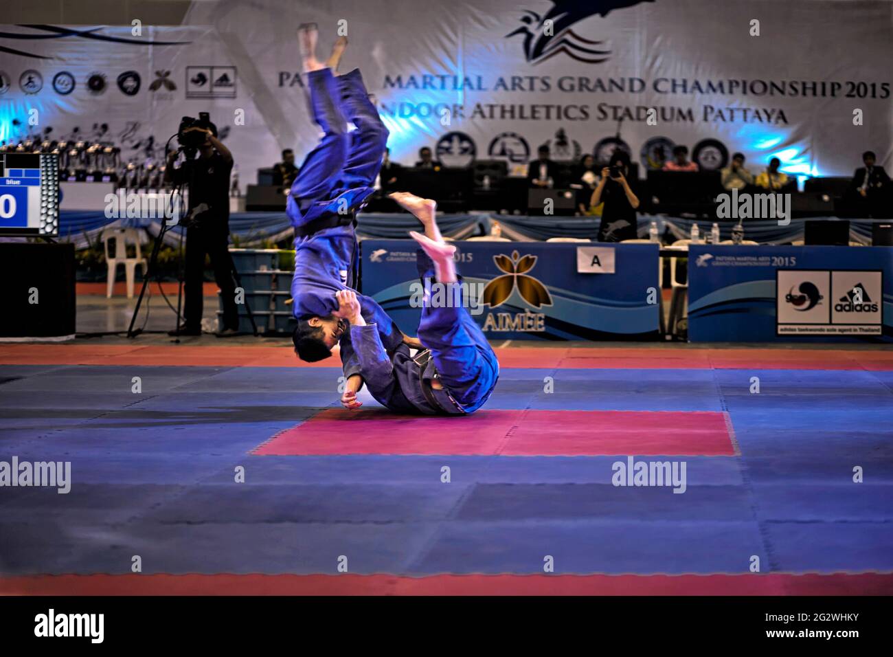 Judo throw nage waza with competitor upended in mid air at a martial arts tournament Stock Photo