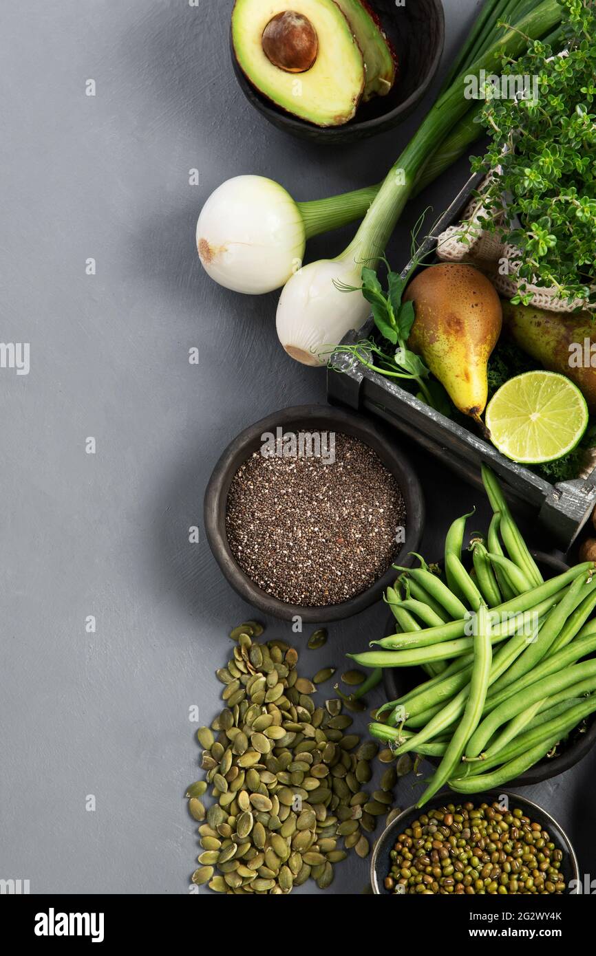 Assorted green vegetables and cereal on gray background. Healthy food ...