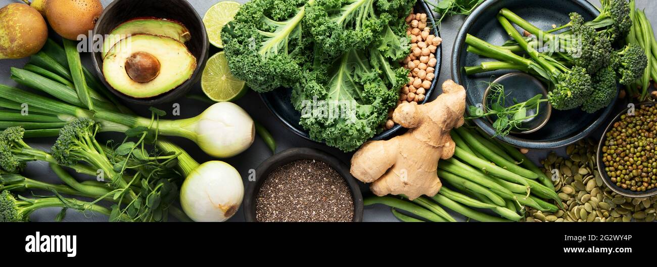Assorted green vegetables and cereal on gray background. Healthy food ...