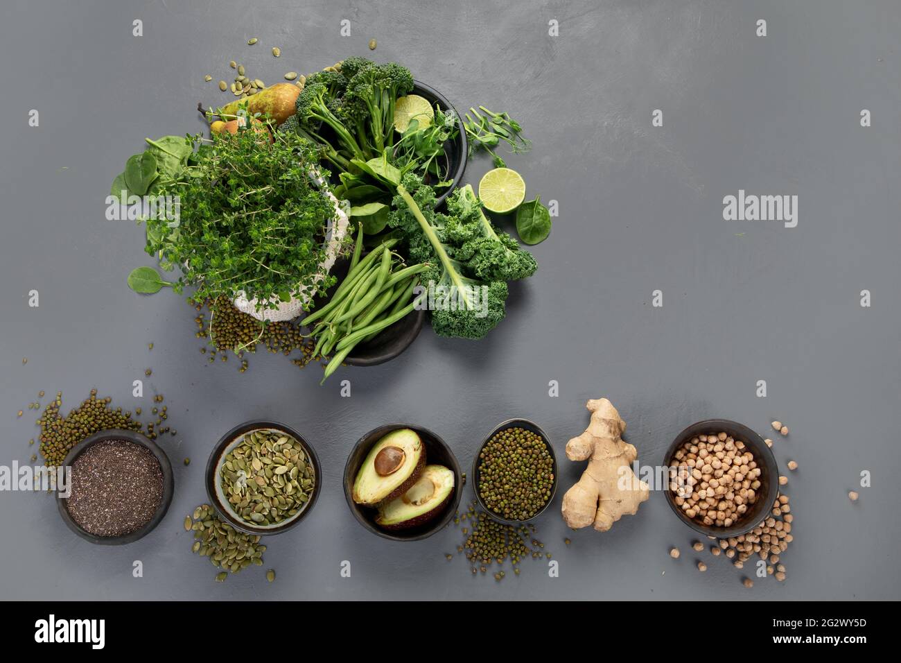 Assorted green vegetables and cereal on gray background. Healthy food ...