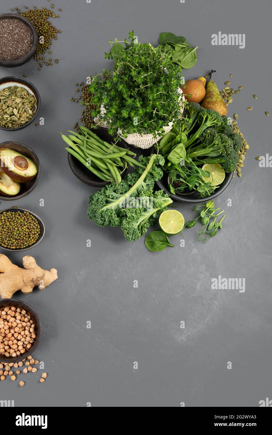Assorted green vegetables and cereal on gray background. Healthy food ...